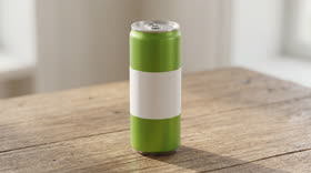 A green can with a blank white label on a wooden table